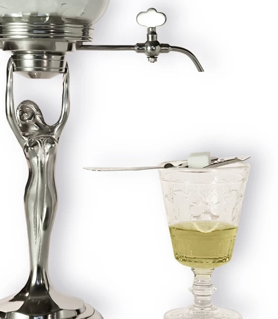 Detail of small metal Lady Absinthe Fountain with glass of Absinthe and a spoon with sugar.
