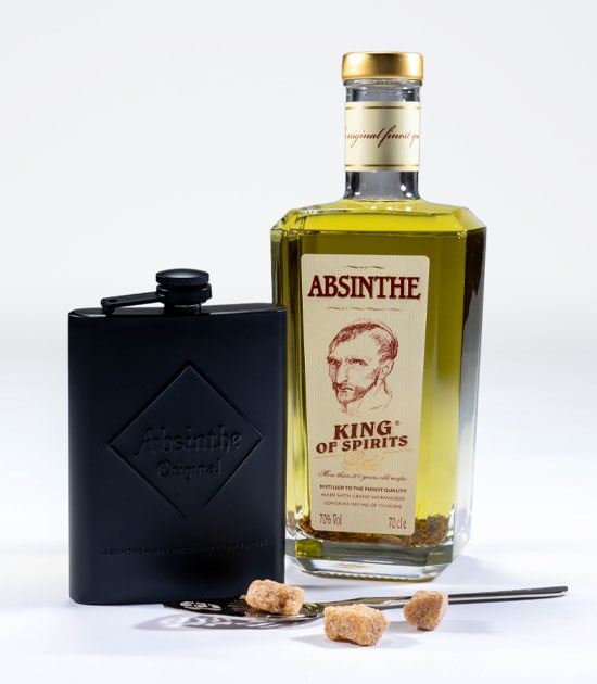 Absinthe spoon with sugar, 700ml bottle of King of Spirits Gold absinthe, and black absinthe hip flask.